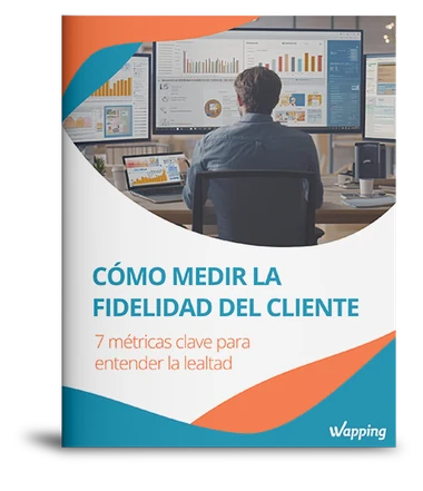 Portada del whitepaper «Cómo medir la fidelidad del cliente» de Wapping, con un profesional analizando paneles de datos
