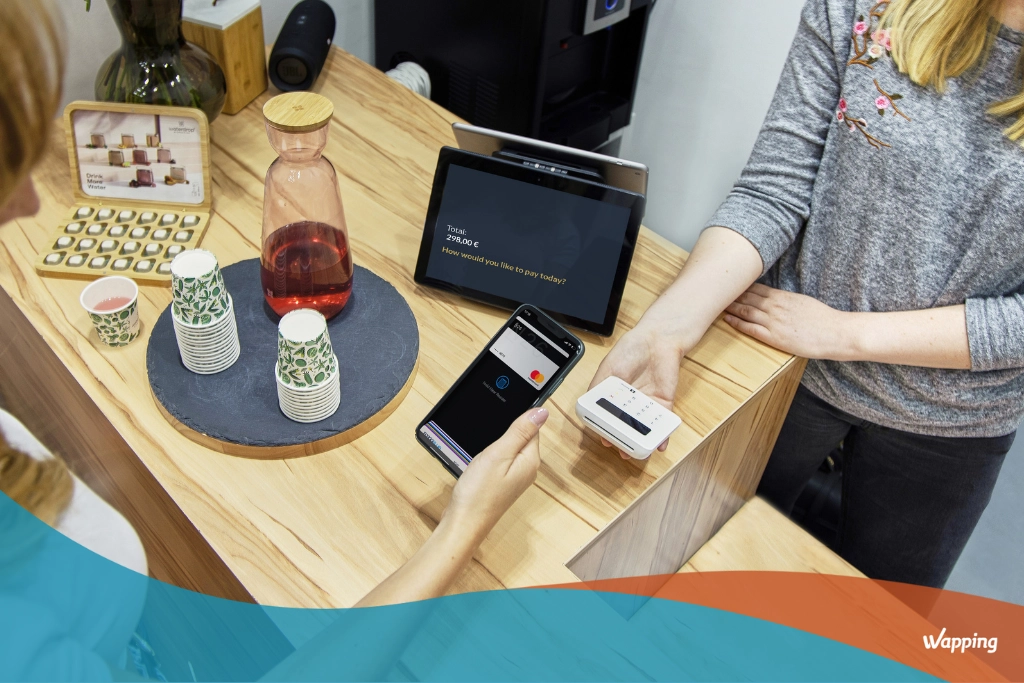 Customer paying at the register with a benefit applied in real time by the headless loyalty & promotion engine